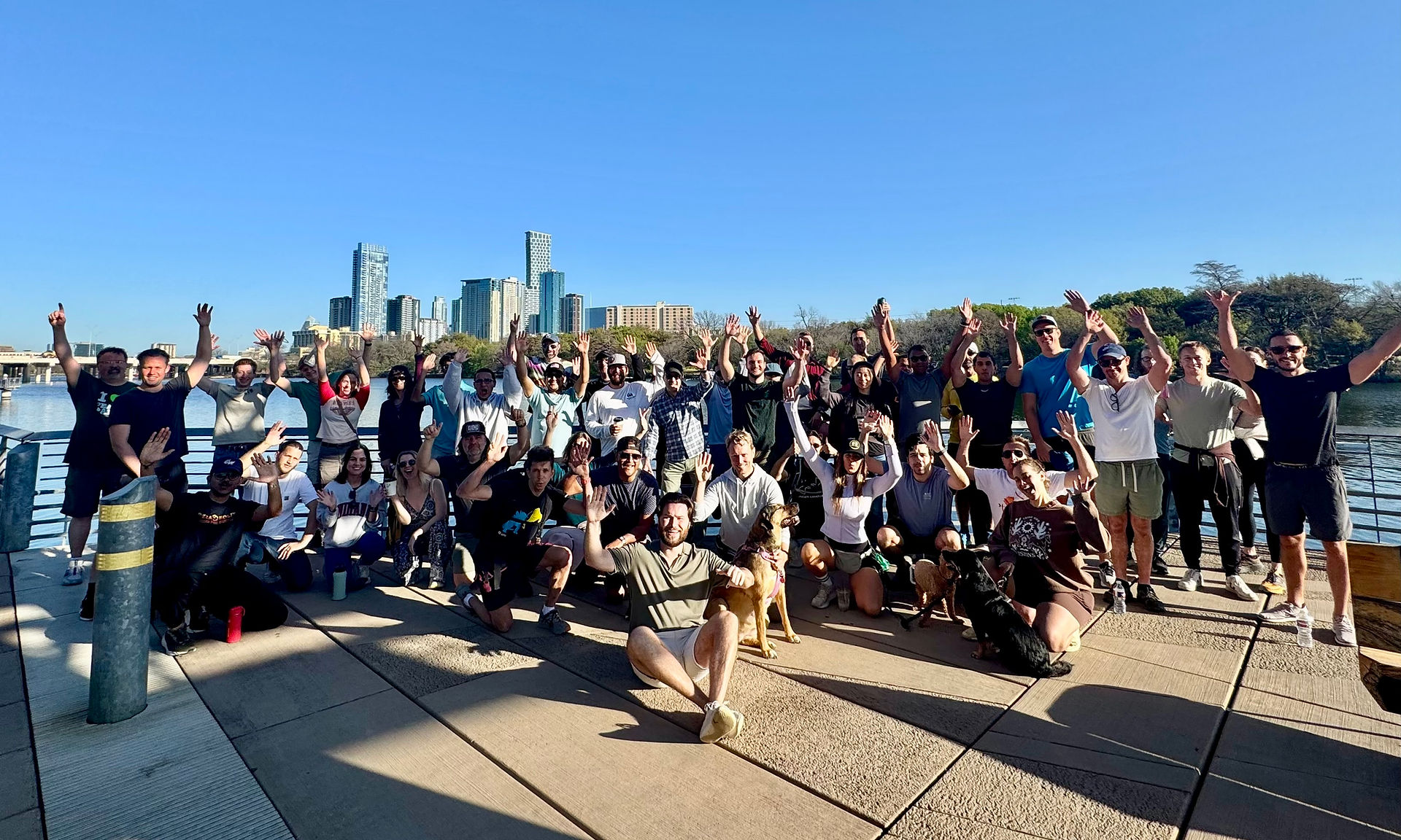 A group showing team leadership by a city waterfront.