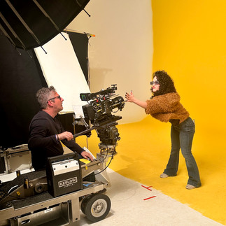 A cameraman and an assistant adjust the camera angle on a yellow background set at Essanay Studios, Chicago.