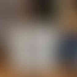 A letter board sign that reads 'Welcome to my home full of love, peace, and good energy,' placed next to a shoe basket by a staircase.