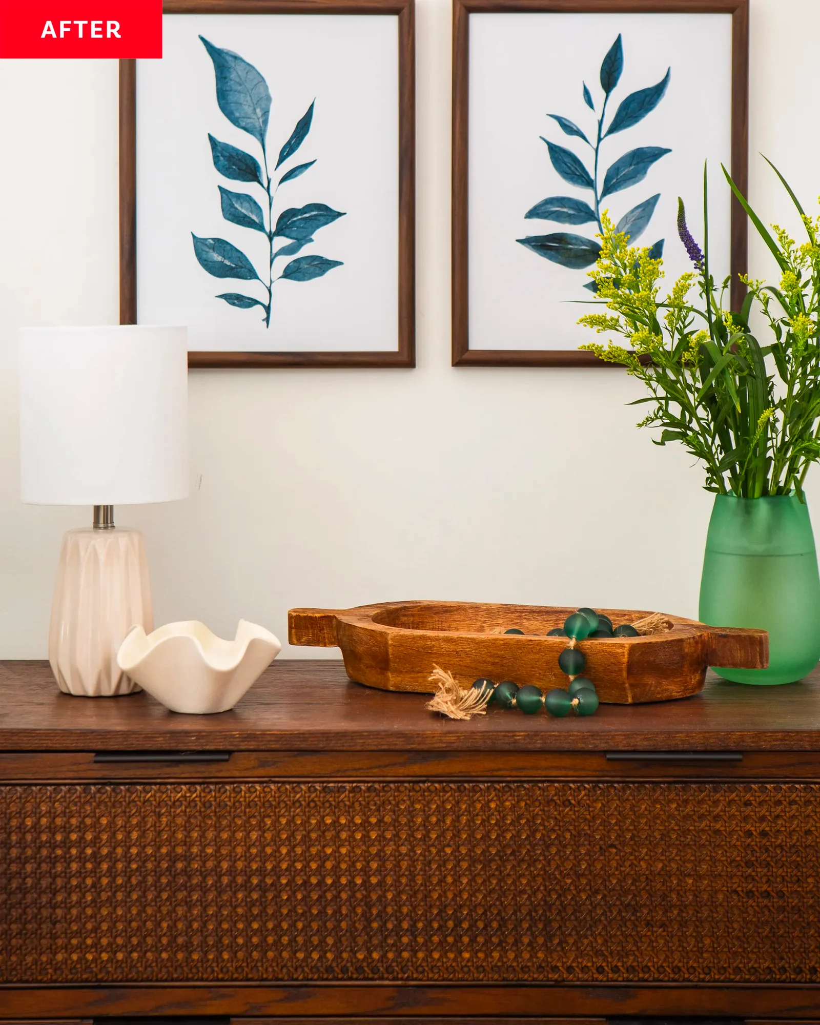 Detail of a carefully styled console table with a contemporary ceramic lamp, decorative wooden tray, and fresh green florals, part of an interior styling project in Belmont Gardens.