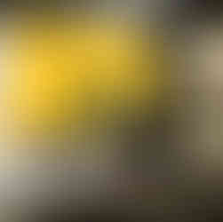 Crew members set up cameras and lighting on a yellow background set for a commercial shoot at Essanay Studios, Chicago.