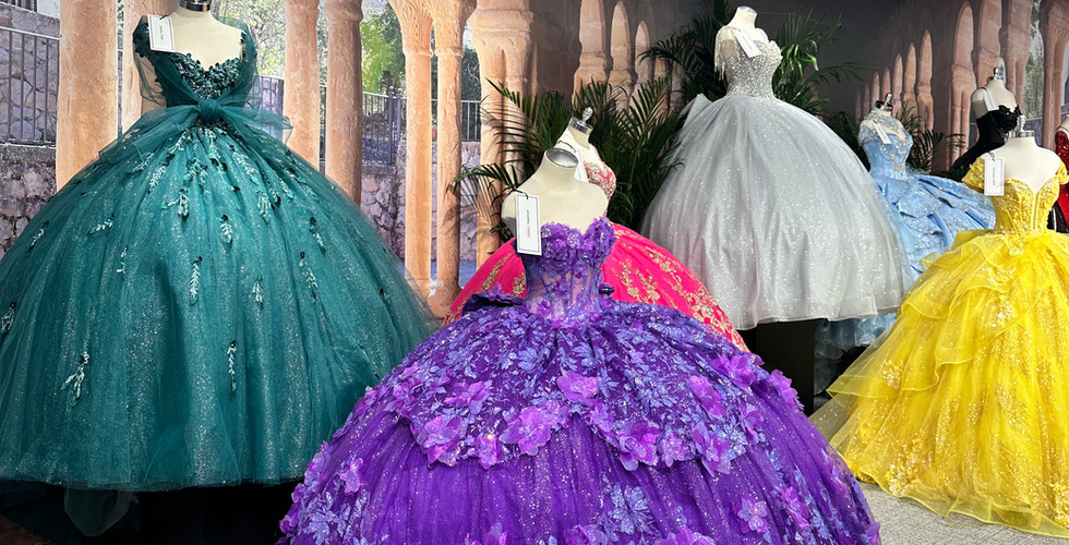 Purple and emerald green quinceañera gowns showcased on mannequins as part of a layered installation at National Bridal Market Chicago.