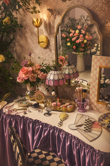 Styled tablescape with MacKenzie-Childs collectibles, florals, and layered props from the MacKenzie-Childs x Wet Brush x Goody shoot.