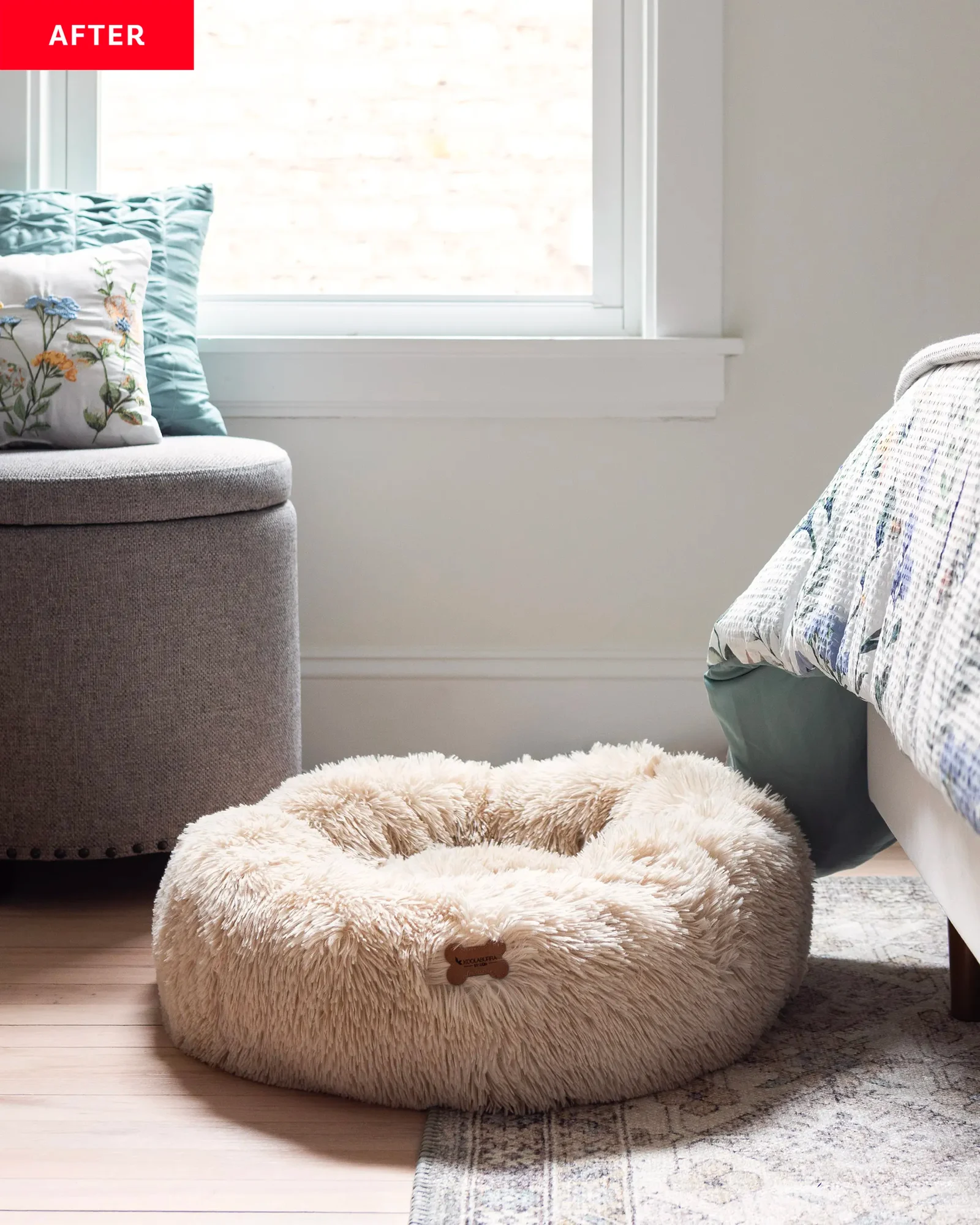 Detail of a cozy bedroom corner in Chicago, Illinois, styled by Amanda Wolfson, showcasing a plush pet bed, soft window light, and textured ottoman, inviting relaxation and comfort.