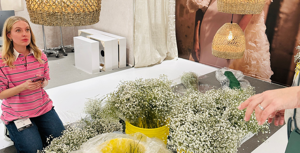 Team members prepping baby’s breath floral bunches at event