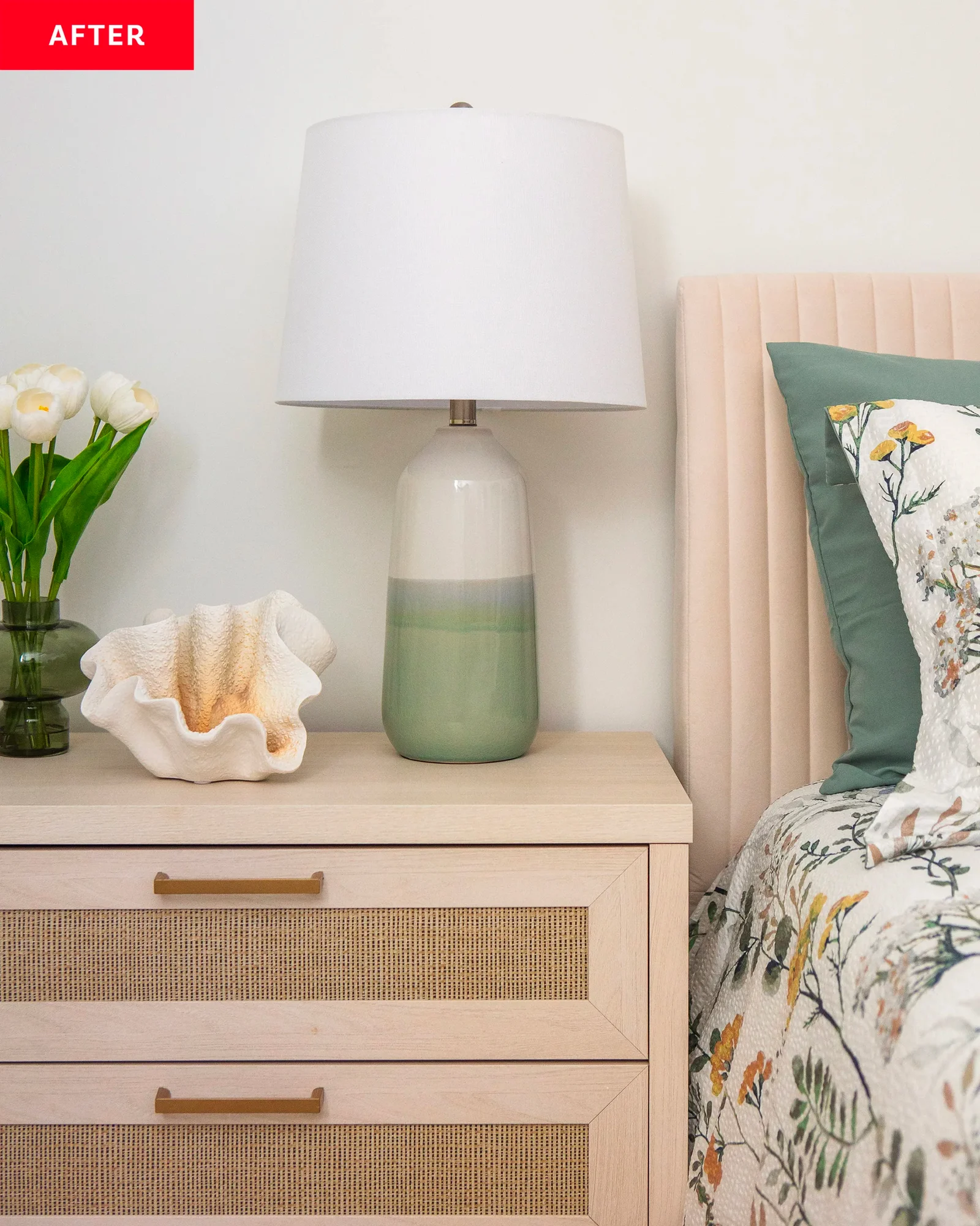 Amanda Wolfson's interior styling finesse is evident in this Chicago, Illinois, bedroom, featuring a modern nightstand with a ceramic lamp, fresh tulips, and a decorative coral piece, creating a tranquil bedside scene.