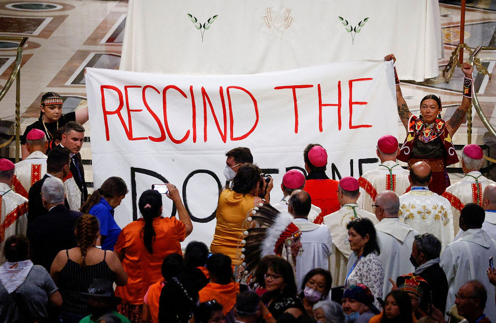 Raising banner, protesters raise questions about 'Doctrine of Discovery'