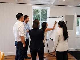 people around whiteboard.png