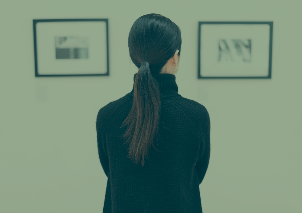 woman-looking-at-the-art-exhibition-P2GT