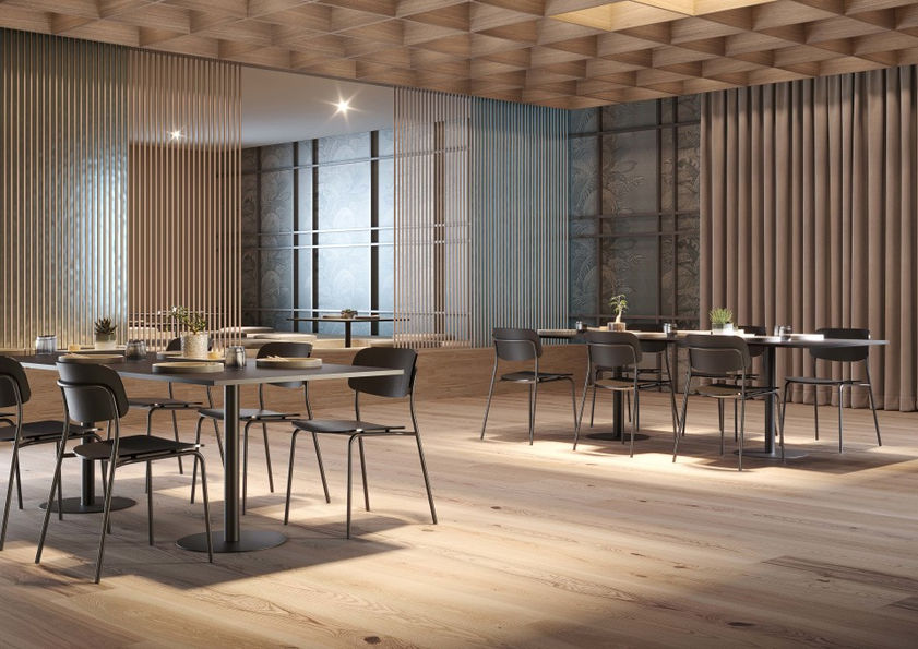 現代餐廳內景,灰色牆壁與橙色地板,圓形吊燈排成一列,白色Daily1椅整齊擺放,背景有拱形門,環境寧靜優雅。