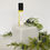 Thumbnail: Amboise perfume oil sits on a marble bookend surrounded by juniper branches with berries.