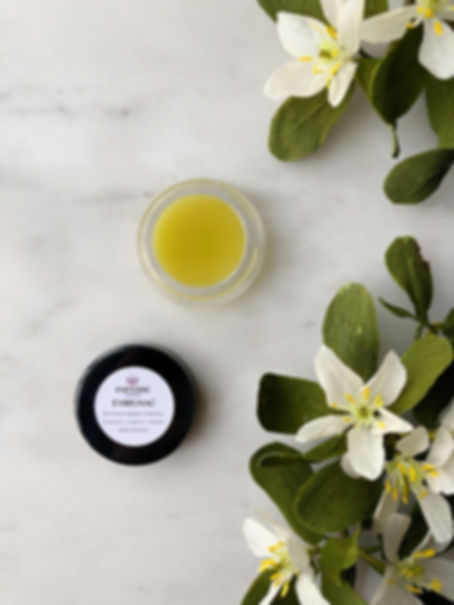Eyrignac all natural solid perfume next to guaiac flowers.
