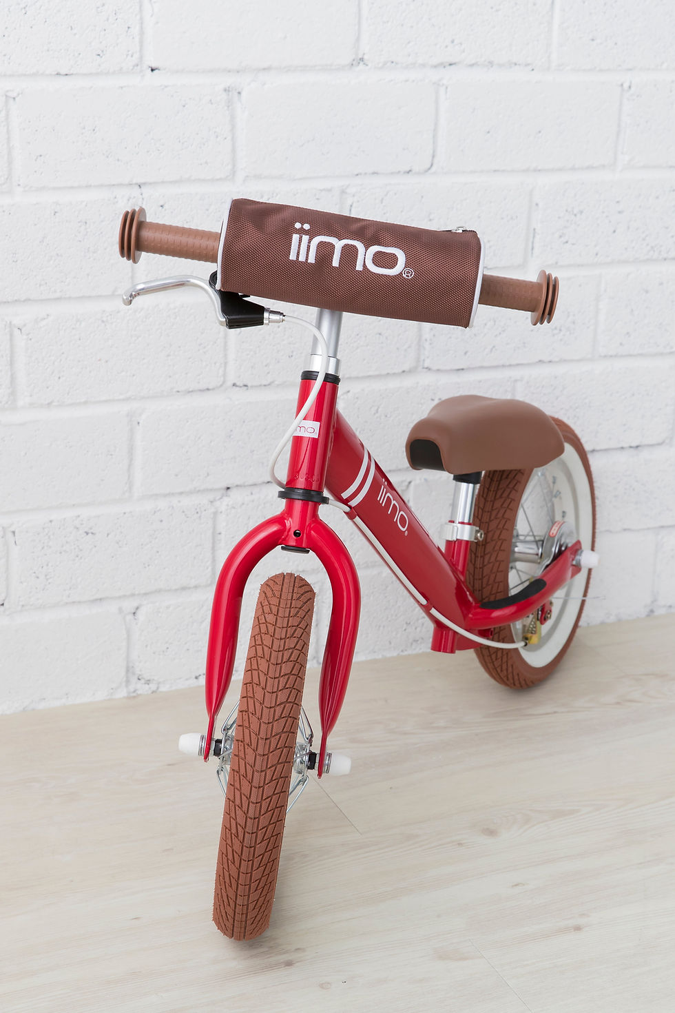 Thumbnail: Red iimo 12-inch balance bike against a white brick wall
