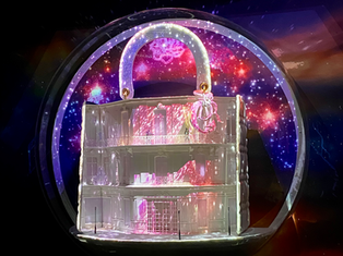 Fireworks explode in "'Dior's Carousel of Dreams' at Saks Fifth Avenue. The production transformed the iconic store's facade and windows with a magical display of animated Christmas scenes and iconic landmarks. The holiday installation featured giant snow globes showcasing Monsieur Dior's journey from Paris to New York and included state-of-the-art video projection mapping, designed by Studio McGuire - Davy and Kristin McGuire.