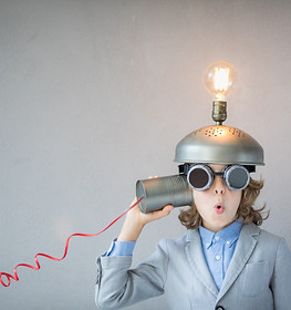 Portrait of child in classroom. Child with toy virtual reality headset in class. Funny kid