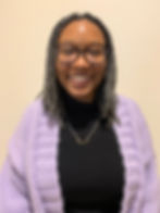 Shila smiling at the camera against a white background