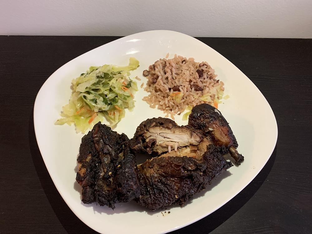 Jerk chicken, rice and beans, and steamed vegetables