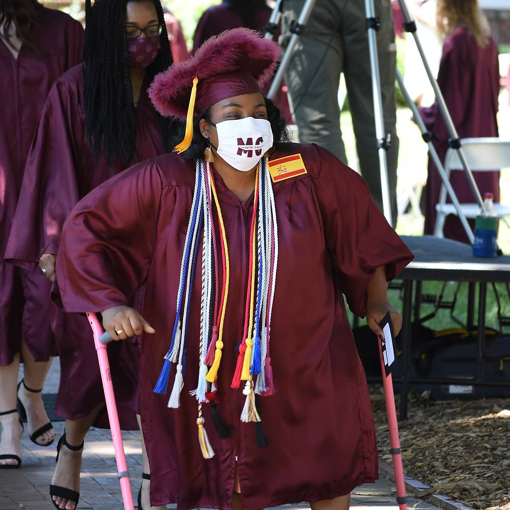 Tasia walking in her cap and gown