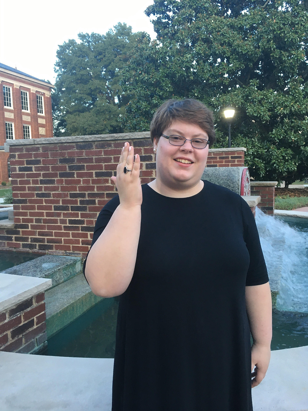 Claire standing by the Meredith fountain with her onyx held up