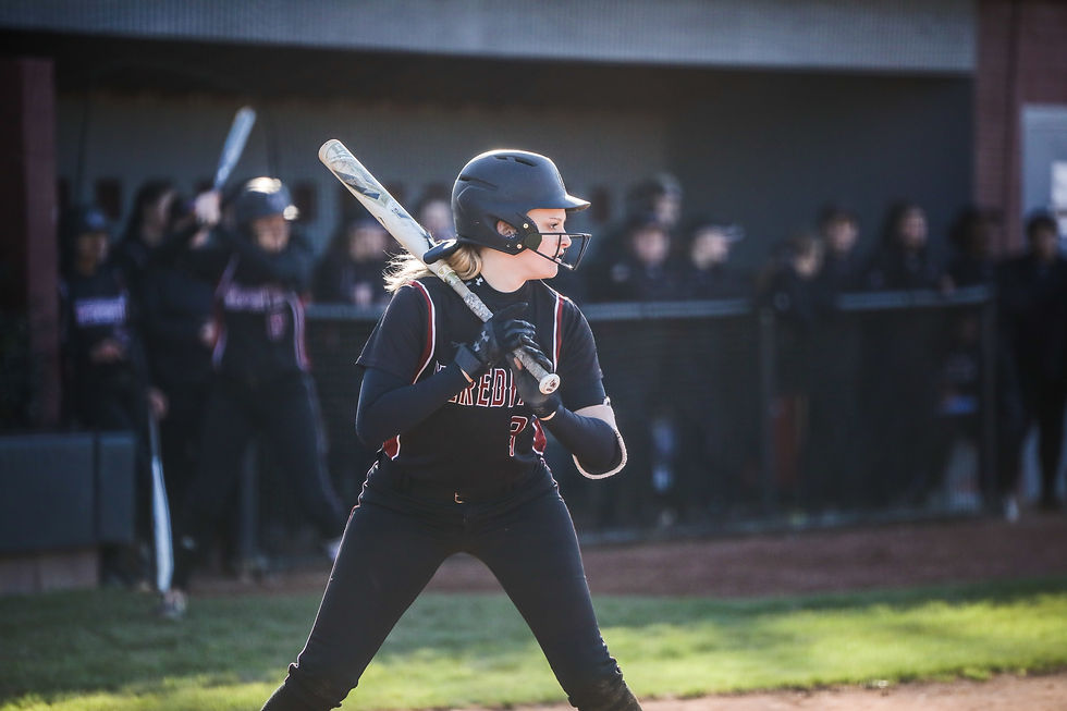 A batter preparing for the ball to be pitched