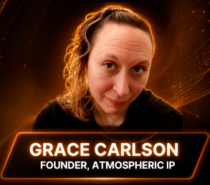 Portrait of Grace Carlson with black hoodie and gold necklace on, looking directly at camera with blonde curly hair going to the right with a shiny hair clip holding it off her face.