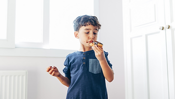 young boy eating cholocate cake