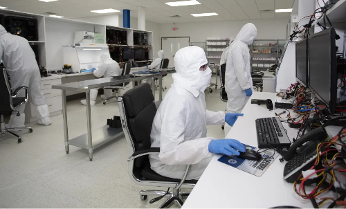 Data recovery engineer testing a smartphone during the diagnostic phase of water damage recovery