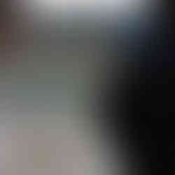 People standing outdoors looking at a map board of “Grutas de Mira de Aire” with a landscape view