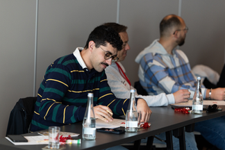 A team member concentrates while marking his bingo card during the quarterly meeting bingo session.