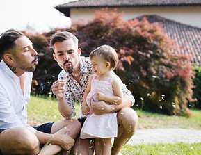 Family Blowing Dandelions