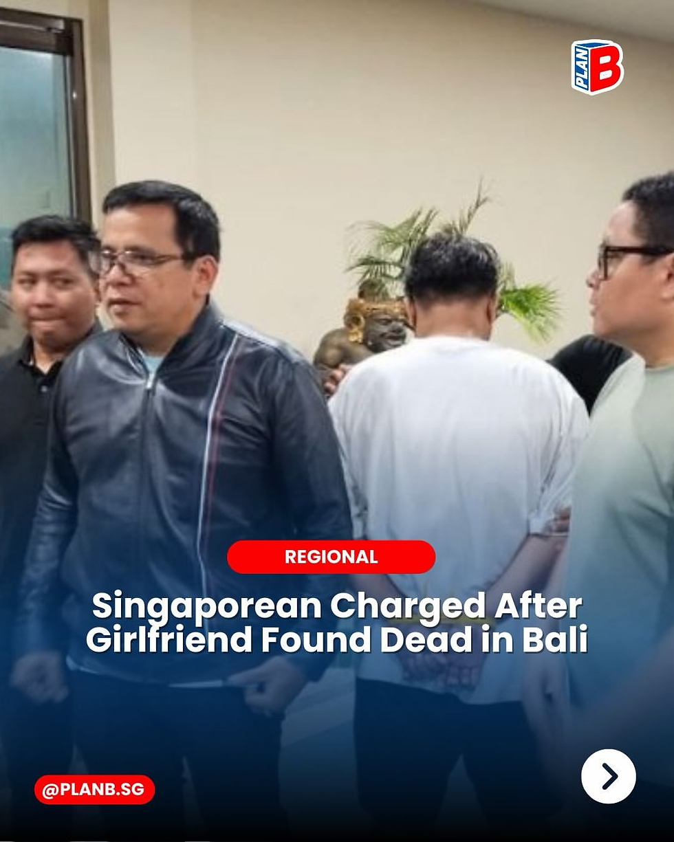 Four men stand in a room beside a plant; news graphic reads Singaporean Charged After Girlfriend Found Dead in Bali.