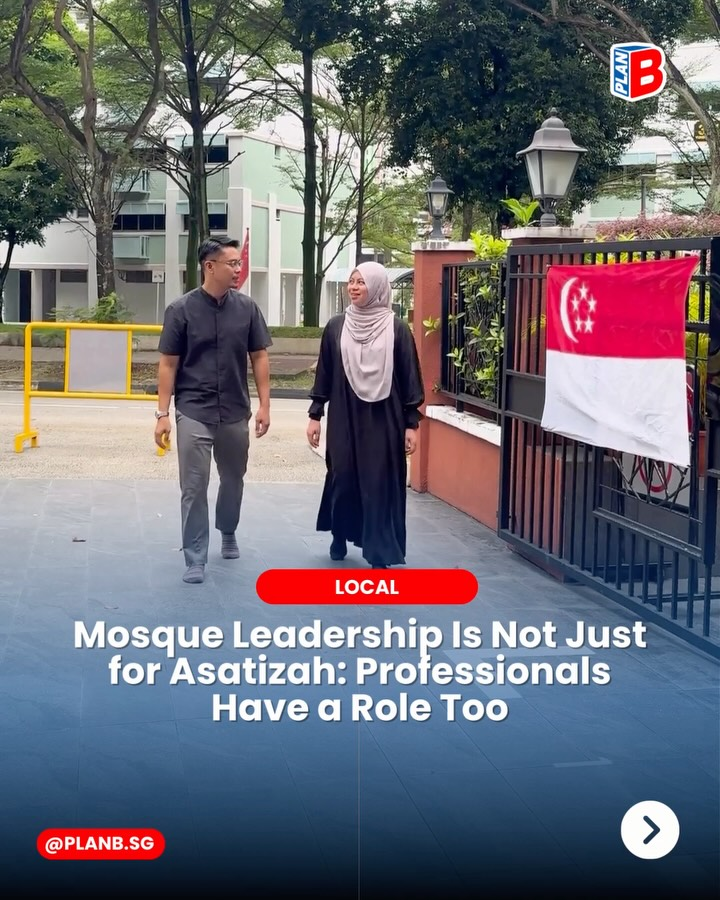 Two people walk outside a gated building beside a Singapore flag, with headline text about mosque leadership and professionals.