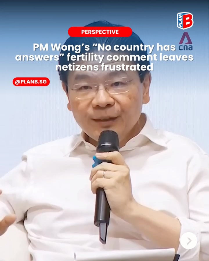 A social media news graphic showing Singapore Prime Minister Lawrence Wong speaking into a handheld microphone during a discussion or forum. The headline reads: “PM Wong’s ‘No country has answers’ fertility comment leaves netizens frustrated.” The graphic is labeled “Perspective” and features Plan B branding.