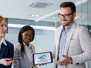Realtors® having a meeting around a tablet with The Sharp Advantage logo on screen.