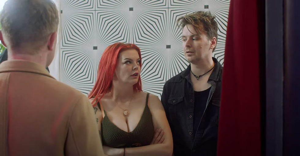 Two attractive people looking at each other suspiciously