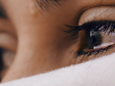 Woman with Tears Hiding Behind a Scarf | Relational Trauma