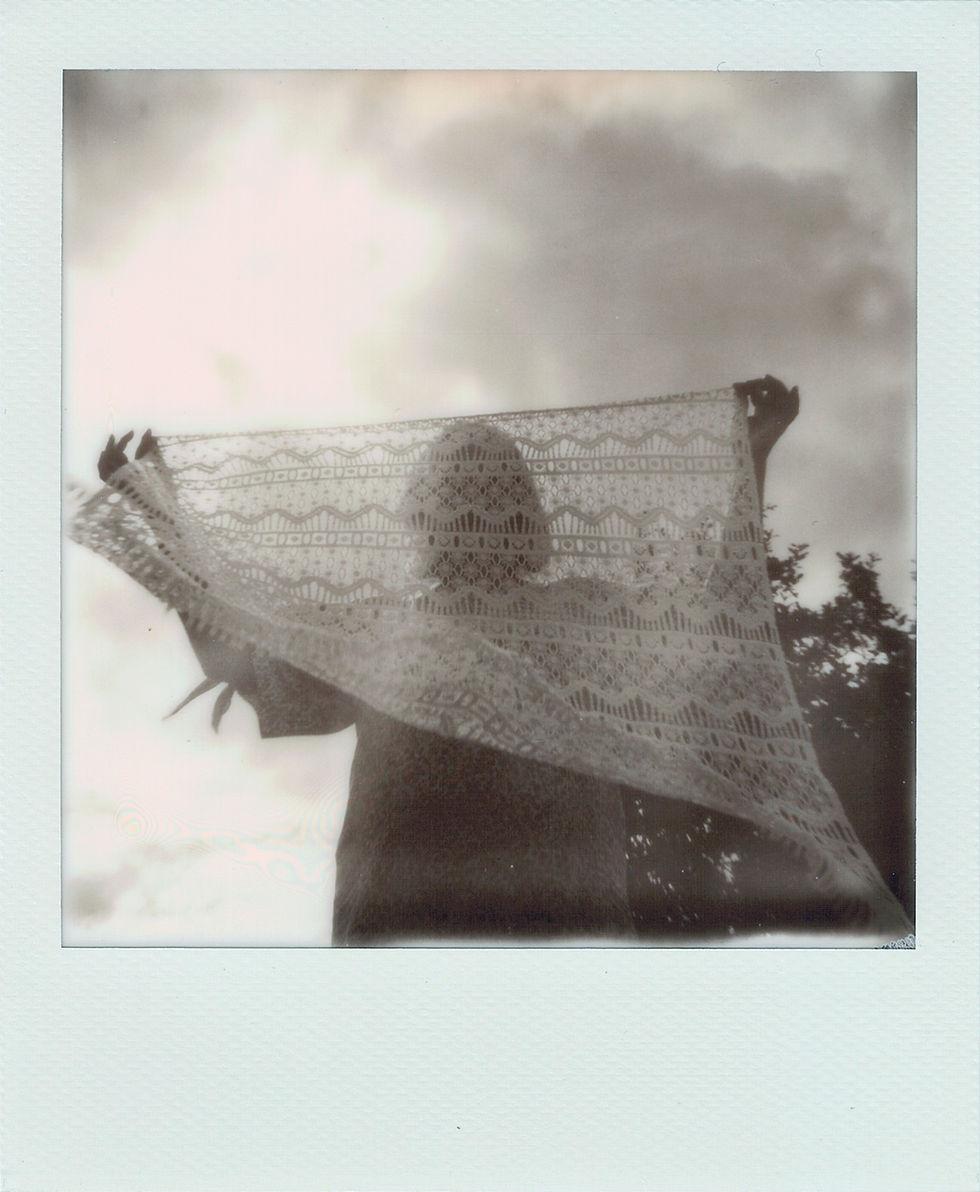 Woman waving a lace fabric against the sun