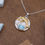 Thumbnail: Silver and Gold Dolphin Necklace with Larimar, Sea Life Seashell Background