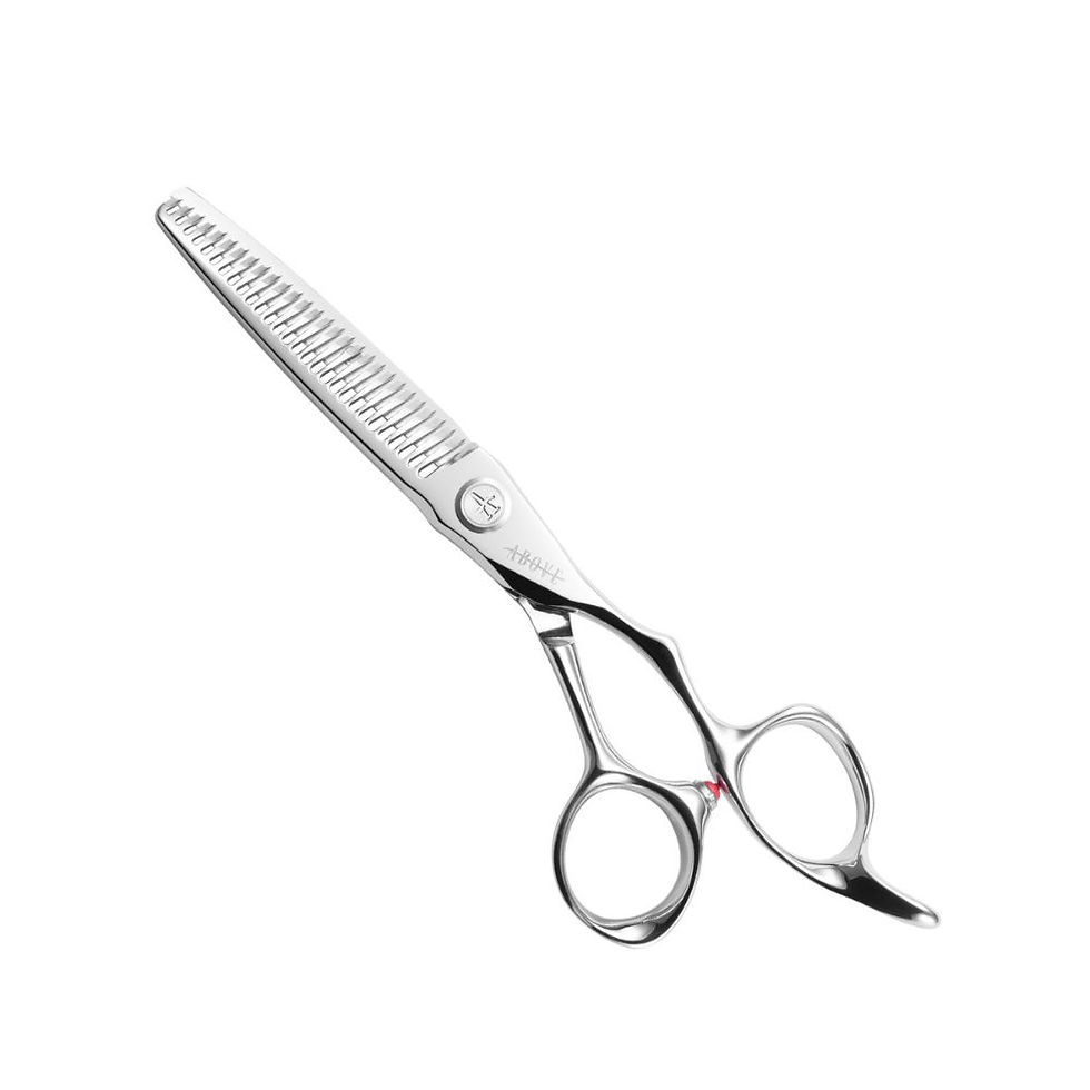 ABOVE Kosmo Finest F6-6028 texturizing shear on white background showcasing its ergonomic offset handle design.