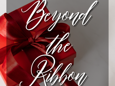 Red gift box with red ribbon on gray background, overlaid with Beyond the Ribbon and sarinamesfin.com, festive and elegant.