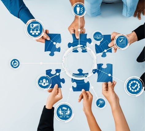 Collaborative business environment where hands complete a jigsaw