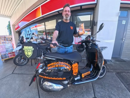 Björn Emanuelsson mit Vespa Roller und SicherheitsCheck Flyer bei der Esso Staion Celle