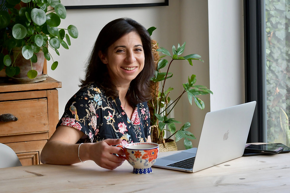 Talia Zamora Business Strategy Coach smiling at her desk