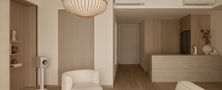 Bright and serene Light Resort Japandi living room featuring neutral beige tones a woven pendant light and cream armchair by Intheory Design Singapore.