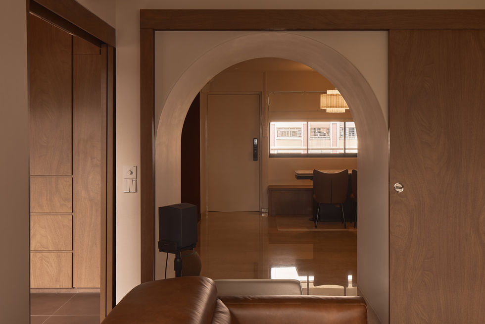 Warm contemporary living area featuring ambient cove lighting, natural timber finishes, and clean architectural lines. Designed to create a calm atmosphere while maintaining an open connection between the home's social spaces.