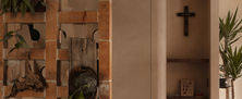 Warm interior feature with terracotta breeze block room divider and illuminated built-in niche displaying decor.