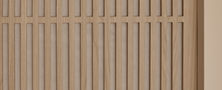 Minimalist light wood vertical slat wall feature creating subtle texture and warmth in a Light Resort Japandi interior.