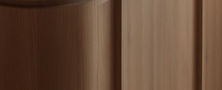 Minimalist joinery detail highlighting smooth rounded timber island edge and durable grey quartz countertop finish.