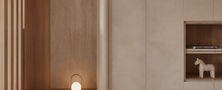 Cozy minimalist entryway nook with light timber slatted screen, built-in storage bench, ambient floor lamp, and neutral wall plaster finish.