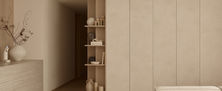 Light Resort Japandi living room joinery with full height beige storage cabinets and corner display shelving for decorative vases.